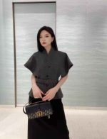 black midi dress and a grey cardigan or cropped jacket.