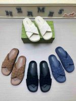Collection of Gucci men's cross-strap slides in white, brown, black, and navy – stylish designer footwear perfect for casual wear.
