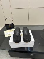 Elegant black Chloé Woody Sandals, showcasing platform thong sandals with their signature ribbed sole, perfect for luxury casual looks.