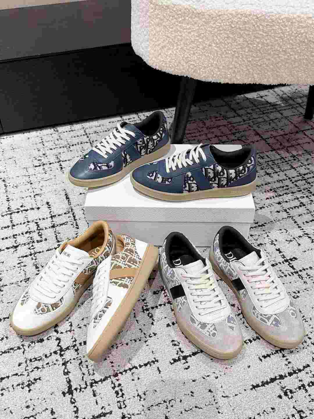 WhatsApp Image 2025-06-27 at 11.41.51 (1) Dior Oblique sneakers in navy, beige, and grey with Oblique monogram pattern and leather overlays on a designer showroom carpet.