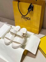 Fendi white slides with gold buckle and white logo sandals on luxury packaging