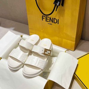 Fendi white slides with gold buckle and white logo sandals on luxury packaging