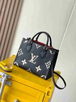 black Louis Vuitton OntheGo luxury tote bag on table