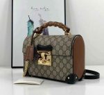 Gucci Padlock Bag with bamboo handle in brown monogram canvas and leather sides, gold hardware, and top flap lock