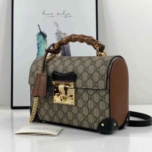 Gucci Padlock Bag with bamboo handle in brown monogram canvas and leather sides, gold hardware, and top flap lock