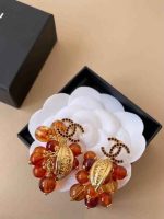 Chanel Camellia floral drop earrings with luxury logo detail