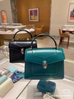 BVLGARI Serpenti leather bag top handle bag in teal and black with signature snakehead clasp