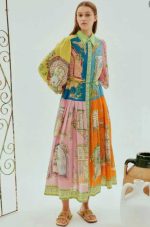 Model wearing a vibrant vintage palace print colorblock maxi shirt dress with puffed sleeves and tie waist.