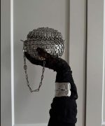 Sporty designer bag, chain-link handbag, fashion-forward accessories