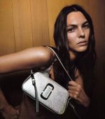 Vibrant pink shoulder bag with silver chain strap; elegant white handbag for stylish use