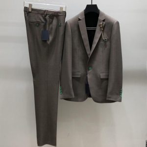 Modern men's two-piece suit in gray with unique green button accents, a tailored formal suit for a professional look.
