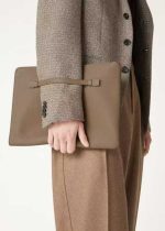 Man holding a brown leather clutch bag, a professional and stylish document holder