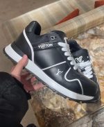 Men’s designer sneakers in black and white, premium style and comfort.
