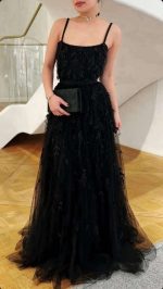 Elegant black tulle gown with feather detailing, perfect for glamorous evening events