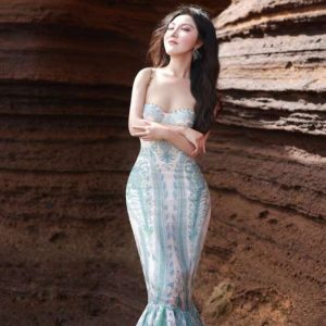 Strapless mermaid evening dress with aqua ocean-inspired patterns, fitted bodice, and flared hem.