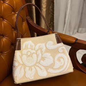 A collage of three images. The top image shows a person holding a woven straw tote bag with a large, embroidered white floral design.