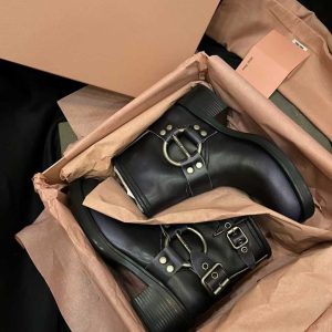 Luxury black leather ankle boots with metallic buckle and stud detailing