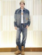 Man wearing a vintage-inspired denim jacket and pants set, showcasing a relaxed street-style look with a comfortable, loose fit.